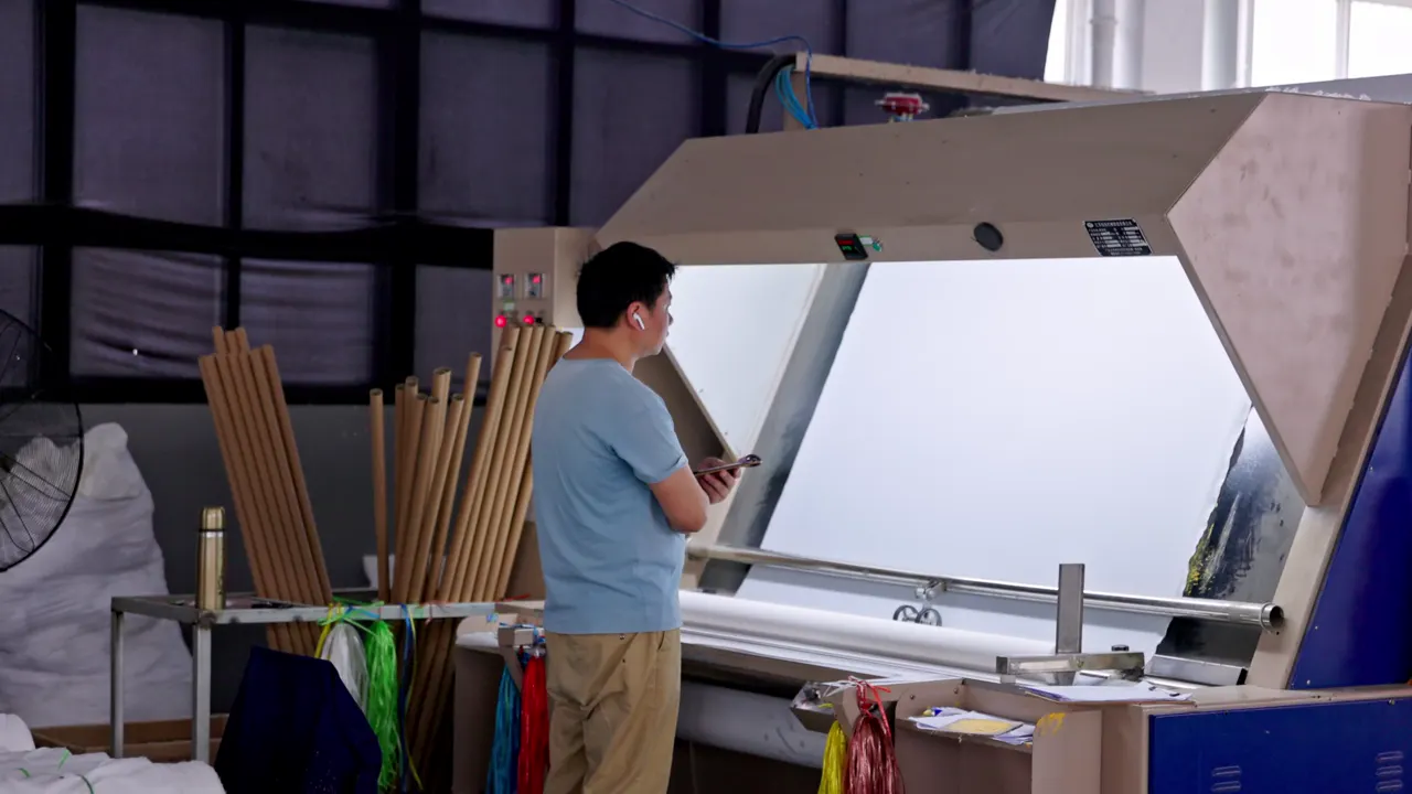 A textile quality inspector working at an illuminated inspection table